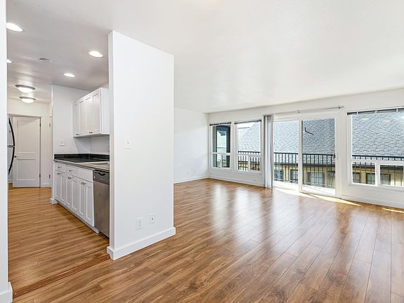 Kitchen and Living Room W/ Sliding Door leading to private balcony