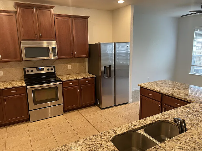 Kitchen with stainless steel appliances + granite countertops + 42 inch cabinets. Fridge included!