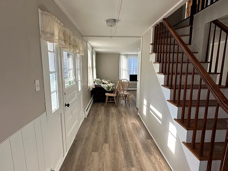 View of living room from dining space, and front door