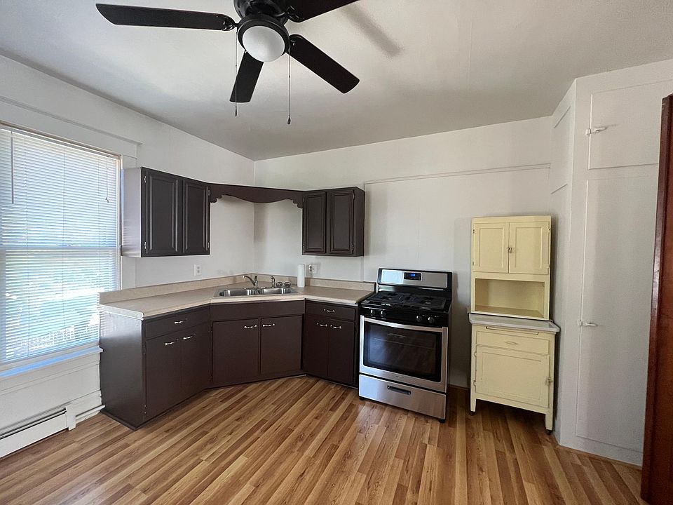Updated kitchen featuring new plank flooring, new gas stove and new refrigerator.