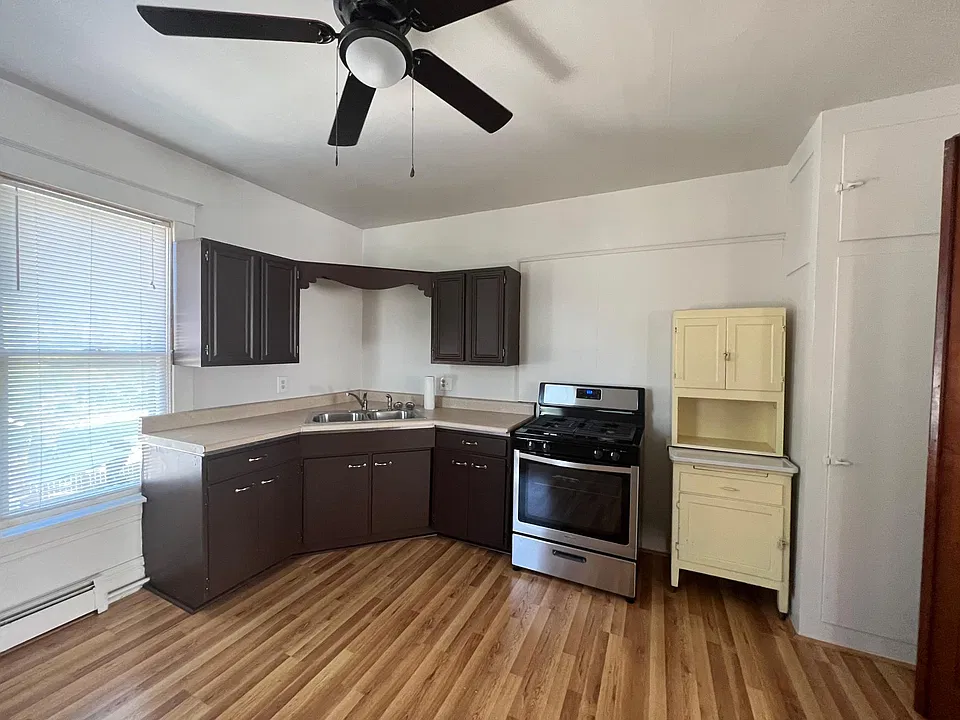 Updated kitchen featuring new plank flooring, new gas stove and new refrigerator.