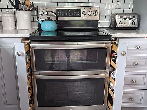 spice racks on side of stove