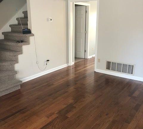 Living room has solid hardwood flooring.