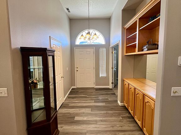 Inside front entry door. Storage cabinets & built in hutch on right