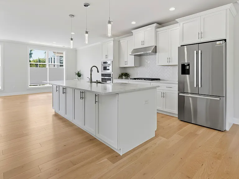 Open-concept eat-in kitchen at the heart of the main living level offers seating space, a pantry and abundant cabinets.
