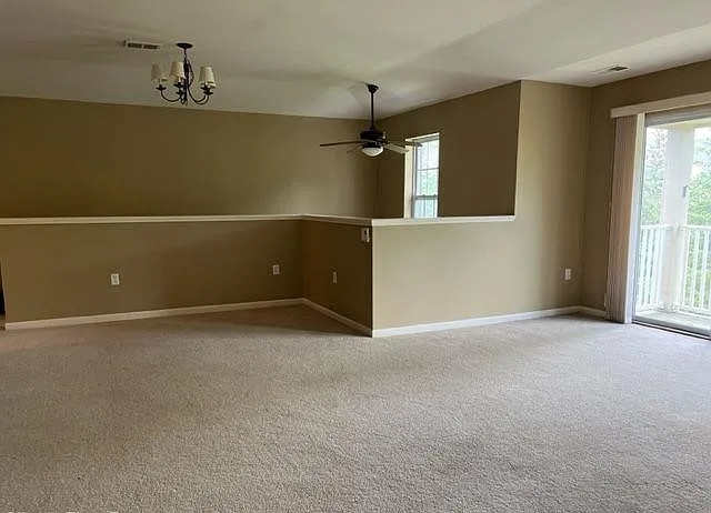 Spacious living room with lots of sunlight along with a walkout balcony
