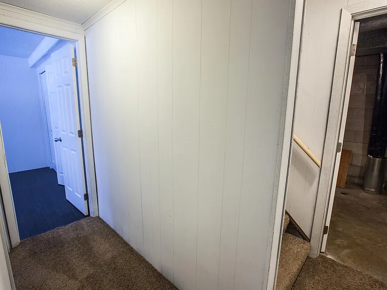 Downstairs hallway to bedroom, stairs and laundry