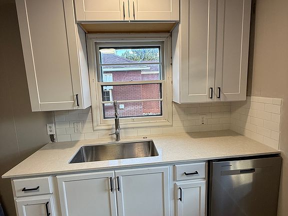 Kitchen; lots of cabinets and cupboards, featuring brand new quartz countertops. Brand new oven range, microwave, fridge, dishwasher, and sink garbage disposal all included
