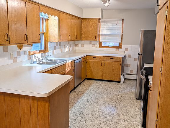 Large kitchen with new refrigerator, dishwasher, and stove