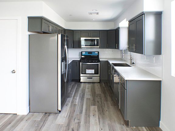 Bright and modern kitchen with stainless steel appliances and quartz countertops