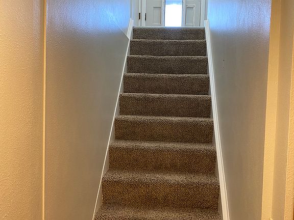 Top of photo shows patio door entry, doggie door, and stairs leading down to apartment.