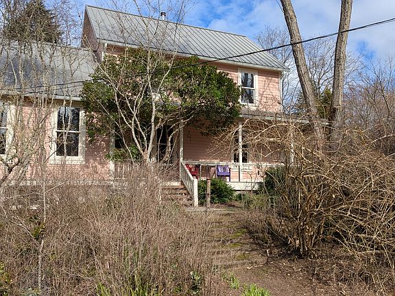 South view of house from lawn. Kitchen to the left, living on right. Bedrooms and second office above