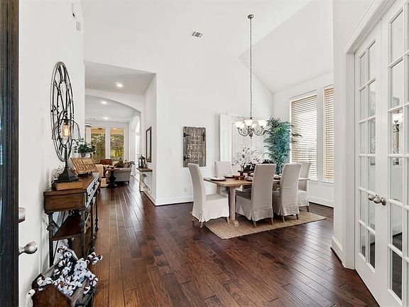 The entrance features high ceilings and an open flow to the study and dining room.