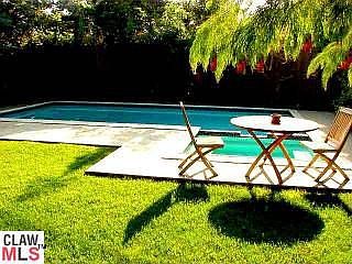 Backyard has a pool/spa as well as a nice grassy area