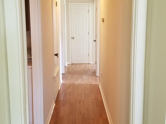 Hallway leading to 3 bedrooms and bathroom