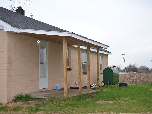 The back of the home features a covered patio perfect for getting into the home in bad weather.