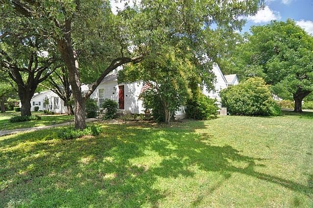 Front yard with large trees, new shutters not pictured