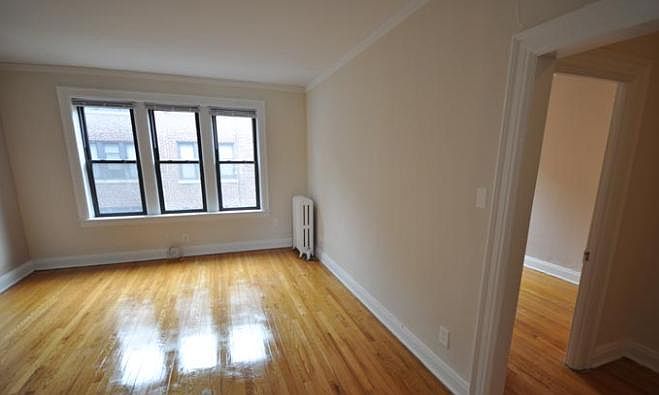 Empty living room view and bedroom door.