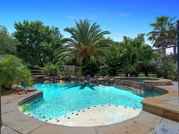 Enjoy your tropical paradise with ultimate privacy on this spacious 1/2 acre lot