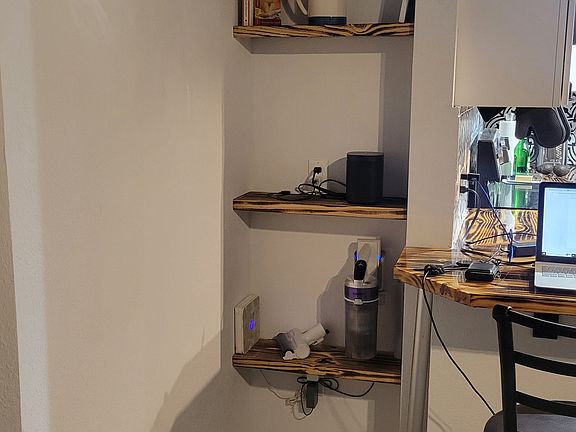 Cozy built in shelving to organize and keep the counter free of mess.