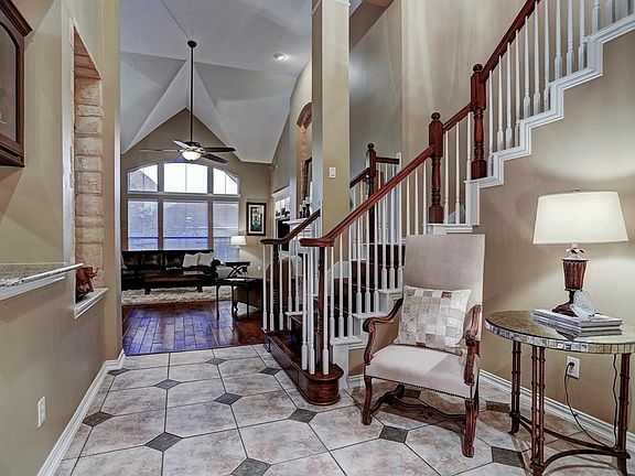 Stunning entrance with gorgeous woodwork and tile flooring.