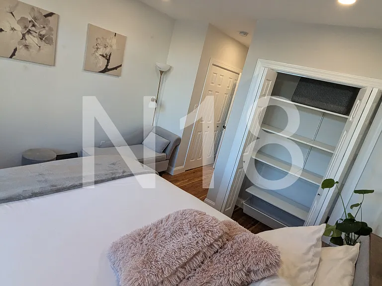 Primary bedroom with en suite bathroom and two closets