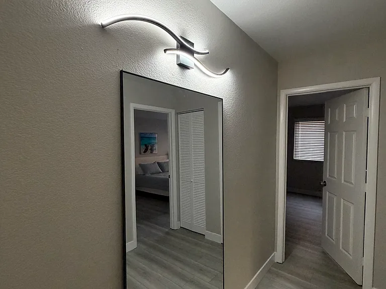 Hallway out of secondary bathroom with easy access to all bedrooms