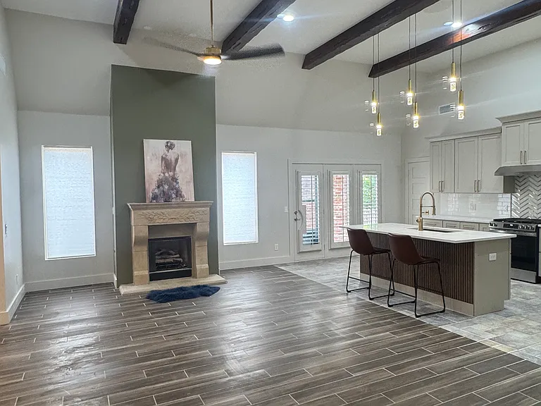 Wood beams, limestone fireplace and tile floors
