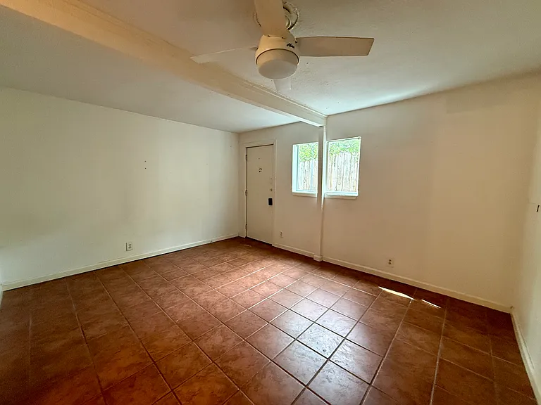 3rd BR with its own private rear entrance that opens out to a small, shady nook and access to the back of the property.