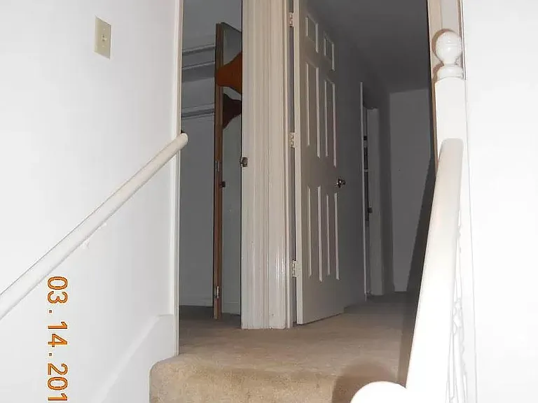 stairs to the 2nd floor viewing 2 bedrooms
