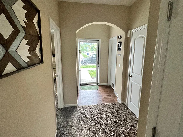 owner suite door on the left, laundry room door on the right by front entrance