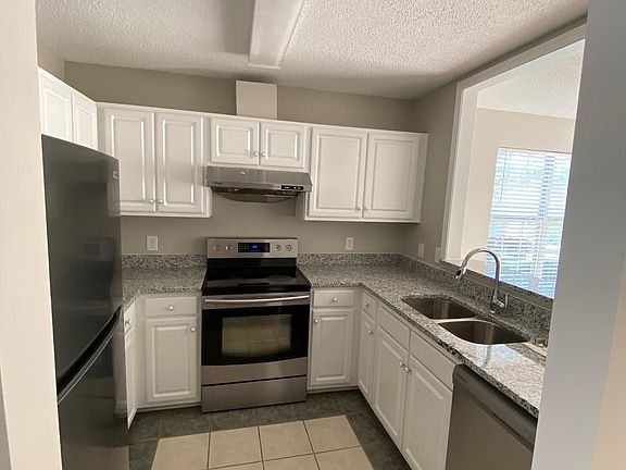 new refrigerator and dishwasher. Stove and range hood is in good condition. Garbage disposal. This kitchen is the perfect cooking triangle!