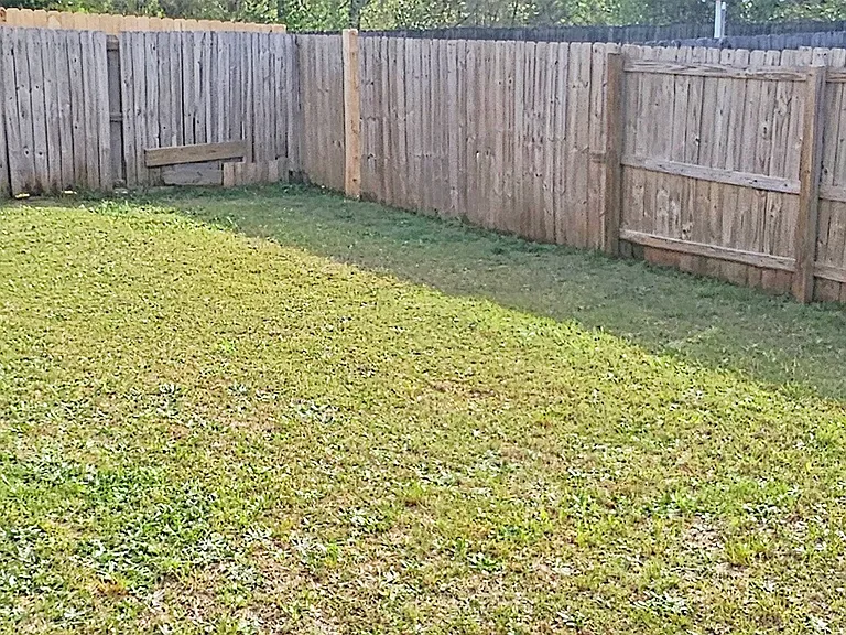 Privacy-fenced-in backyard with plenty of space.