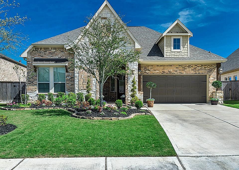 Beautiful stone and brick elevation on this Village Builders one story home