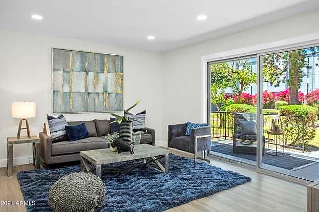 Lovely living room with views of the lush grounds and green grass & Camelback Mtn!