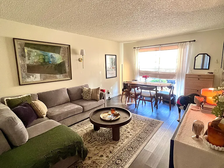 Furnished neighboring unit shown for living room layout reference