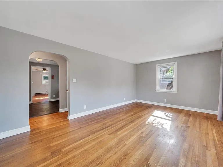 Spacious Living Room w/ Hardwood Floors! NEW Black Matte Curtain Rods Installed by Landlord!