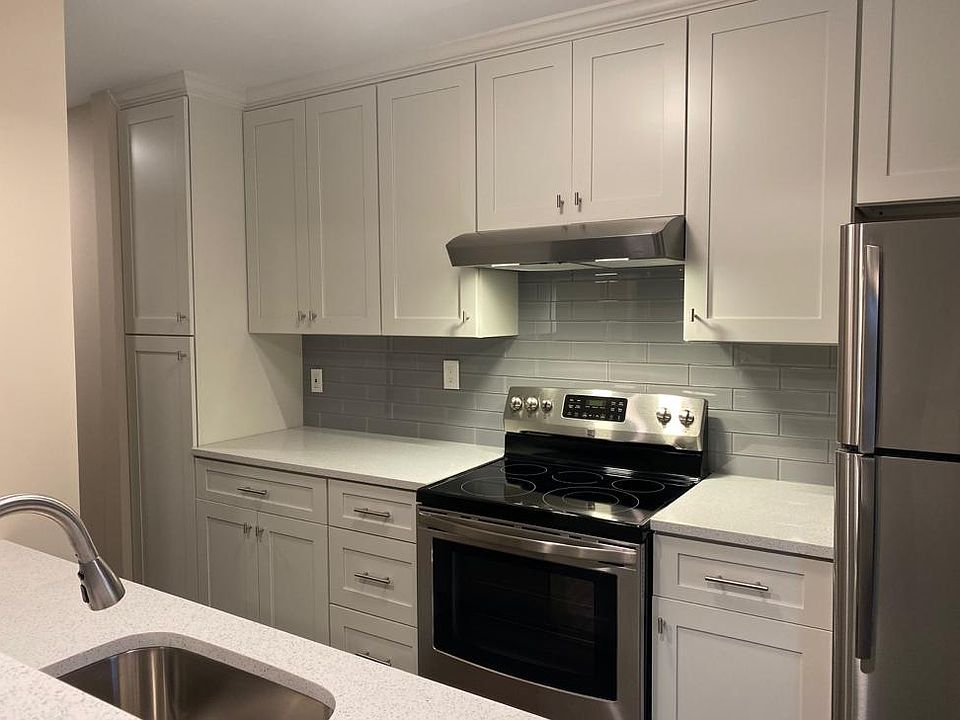 Totally renovated kitchen with quartz countertops, shaker cabinets, stainless appliances