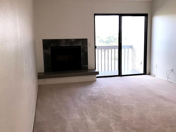Living Room. Balcony overlooks Tecolote Canyon and golf course.