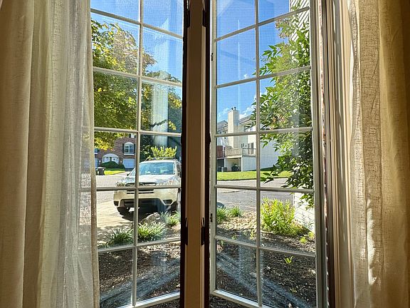 Bright living room overlooking the private two-car driveway