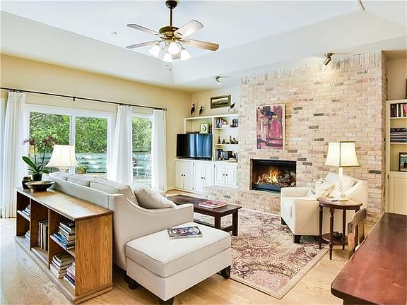 Enter from foyer into large living area with gas fireplace.Built in shelves on both sides provide de
