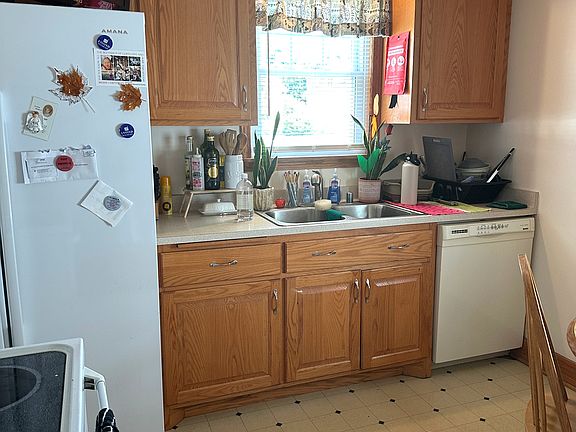 Kitchen includes side by side refrigerator & dishwasher
