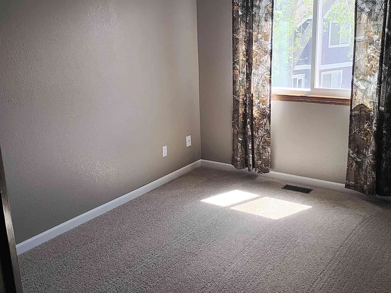Additional bedroom with muted colors.