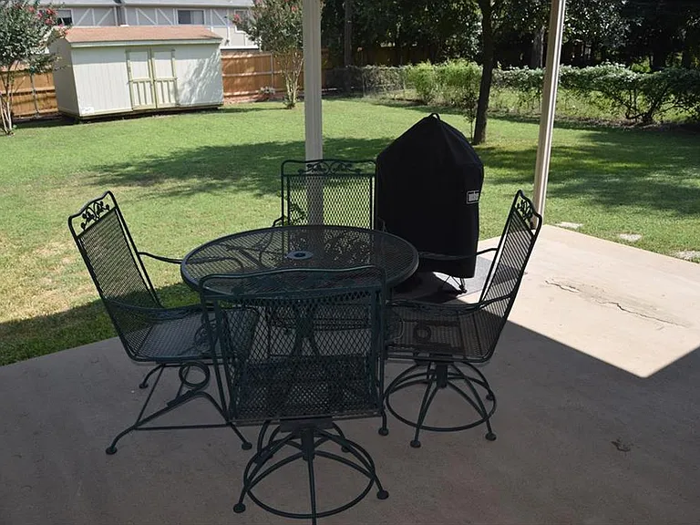 Covered back patio, overlooking large fenced yard.