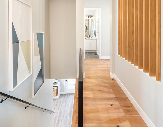 Spacious hallways and stairs that lead to a finished basement
