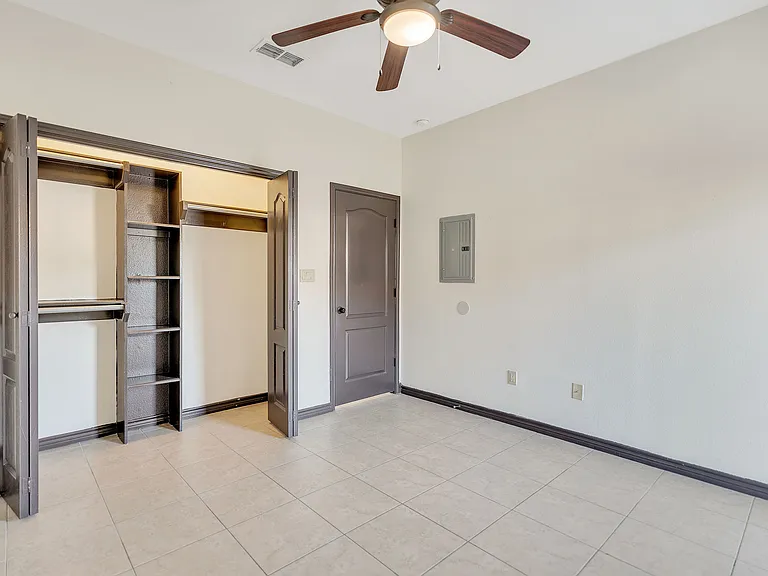 Unfurnished room at Merida Vista Apartments in Laredo, Texas, with a ceiling fan and a closet visible