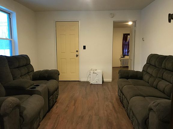 Living room looking at exit to front door on left and bed #2 on the right.