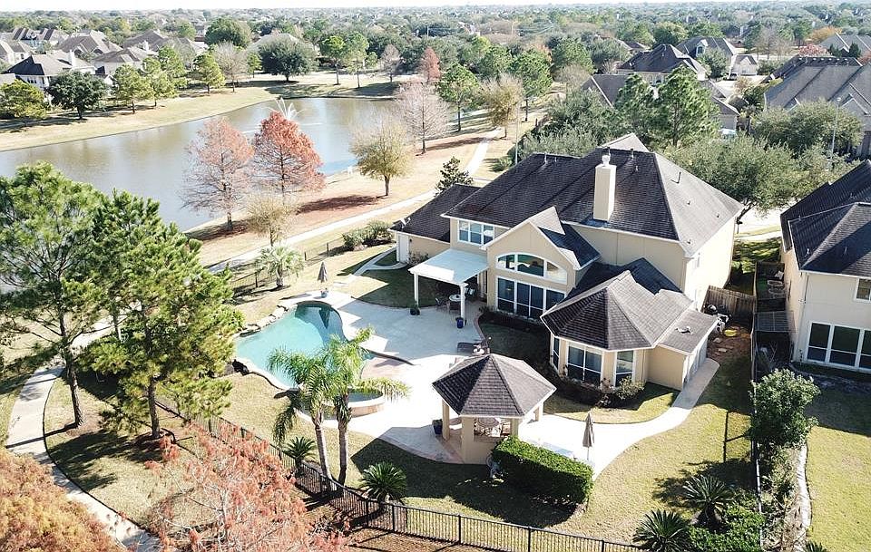 This beautiful home was completed by Stonebridge Homes in 2001. It sits on a lot of outstanding views and contains 12,693 sqft (per HCAD) with wrap around water and views of two fountains.