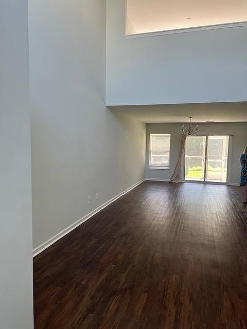 Enter into an open floor with high ceilings and beautiful floor