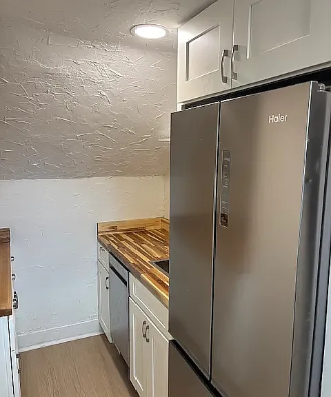 Newly remodeled kitchen w/ new refrigerator and dishwasher. A new venting skylight with shade was installed and also has electric stove.